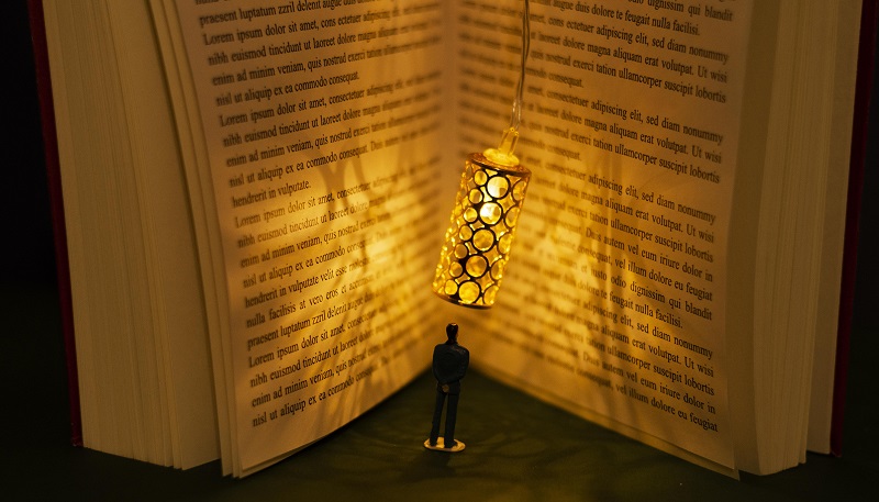 Livre ouvert avec personnage devant